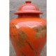 Lovely coral colored temple jar with gilt crane motif